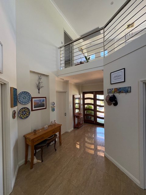under eaves 3 Spacious modern foyer with staircase and decor.