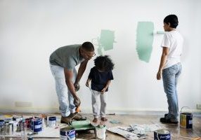 family painting a wall